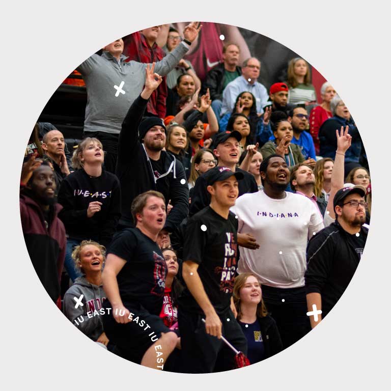 Fans cheer on the IU East Red Wolves at a basketball game.