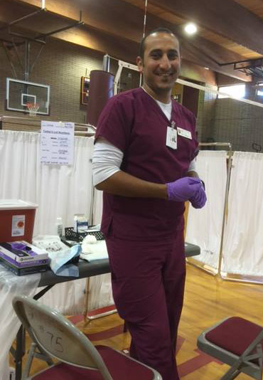 Male nursing student serving in community health clinic.