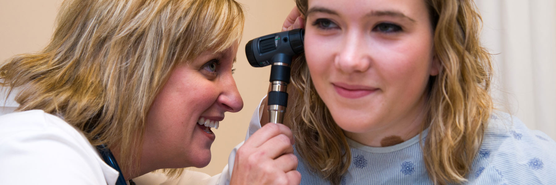 IU East Nursing student examining patient's ear with an otoscope.