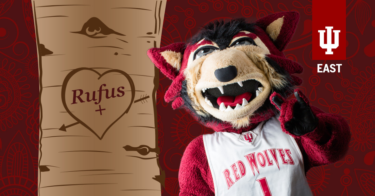 Rufus the Red Wolf with his name in a heart on a tree.