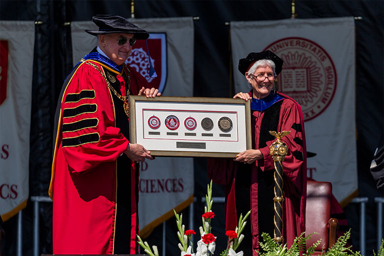 Chancellor Girten presents former IU President McRobbie with the regional IU campus Chancellor's Medallions.