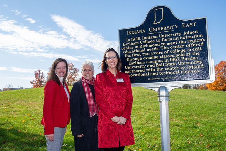 Chancellor Girten and friends with the Indiana landmark sign freshly installed on the IU East campus.