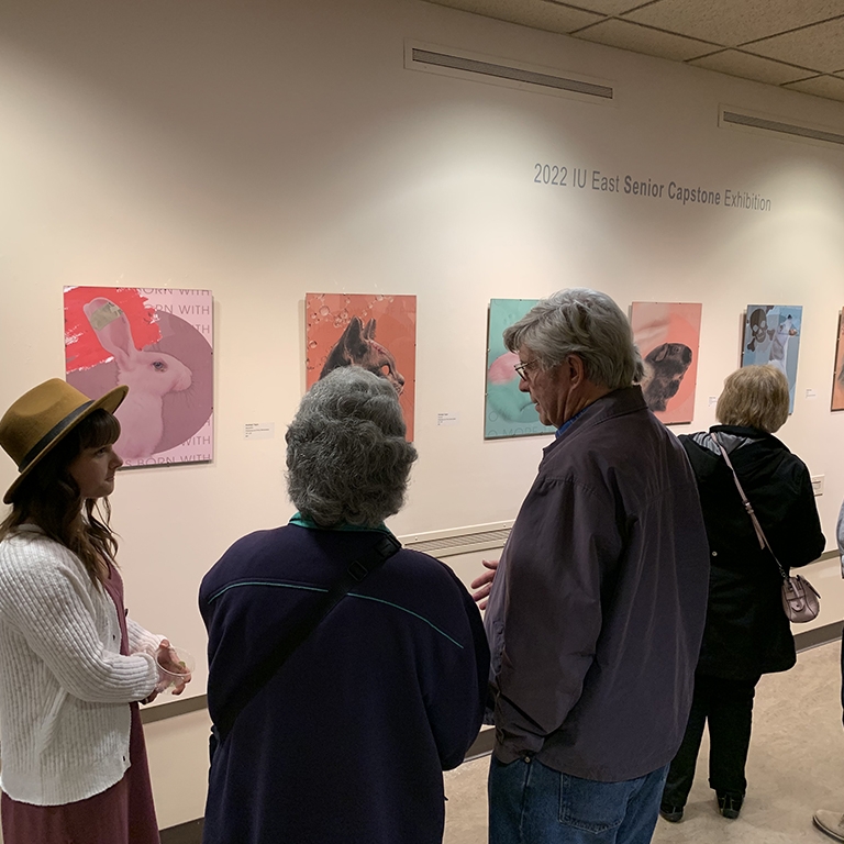 The IU East Senior Art Exhibition is now on display until July 8. Graduating seniors complete an intensive capstone course each spring. The exhibition features the senior capstone projects of five seniors: Paige Burns, Brendan Harris, Tobias Pelfrey, Shaleigh Tague, and Lissa Thomas.